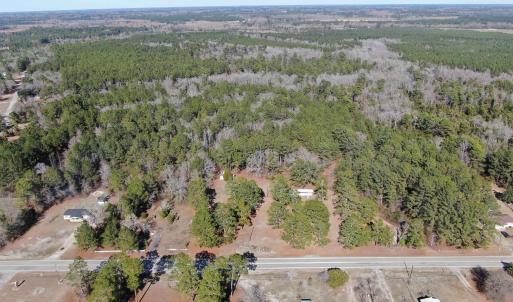 Birds eye view of property with a forest view