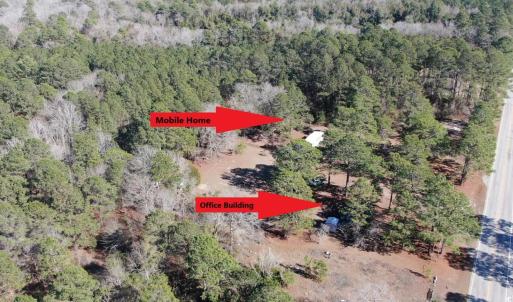 Aerial view featuring a wooded view