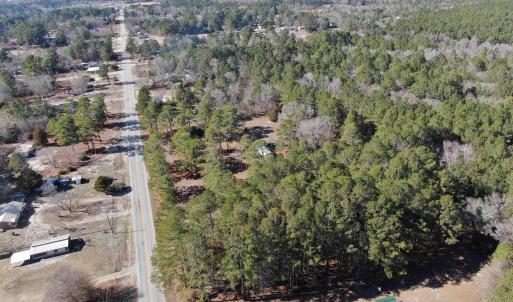 Aerial view featuring a view of trees