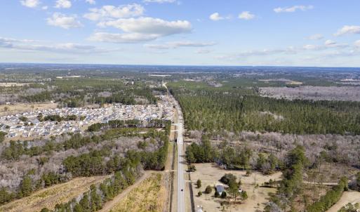 Birds eye view of property featuring a wooded view