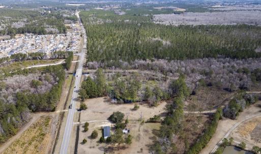 Birds eye view of property with a view of trees