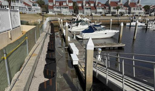 Dock area featuring a residential view and a water