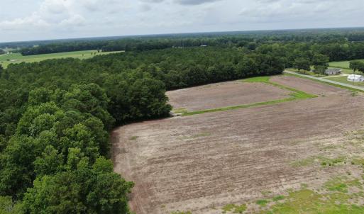 Bird's eye view featuring a wooded view and a rura