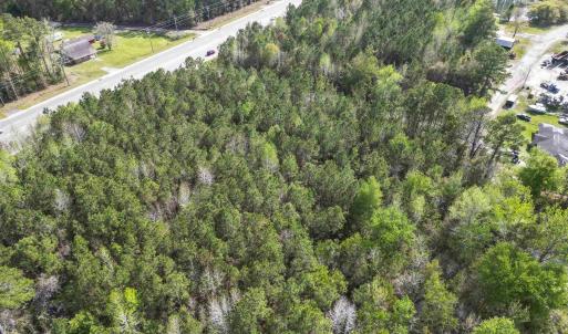 Birds eye view of property with a forest view
