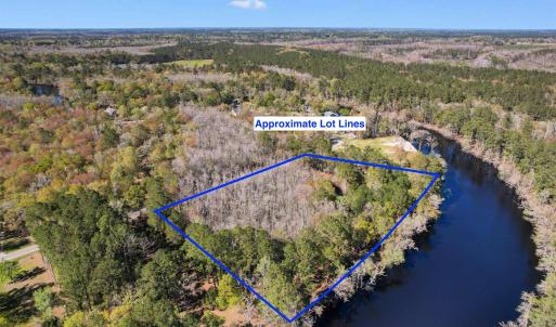 Aerial view with a water view and a forest view