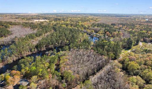 Birds eye view of property with a water view and a