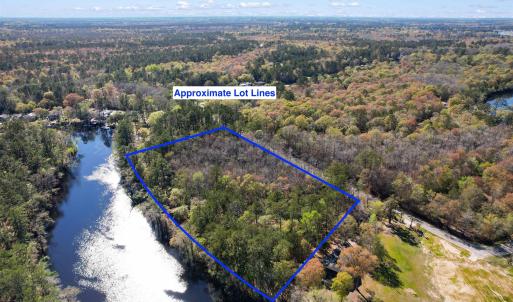 Birds eye view of property with a water view and a