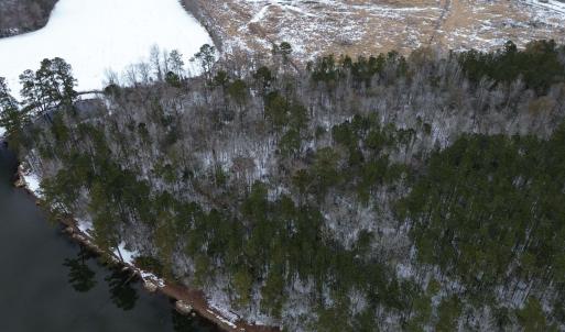 Birds eye view of property featuring a forest view