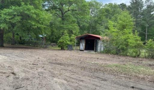Exterior space featuring a detached carport and fe