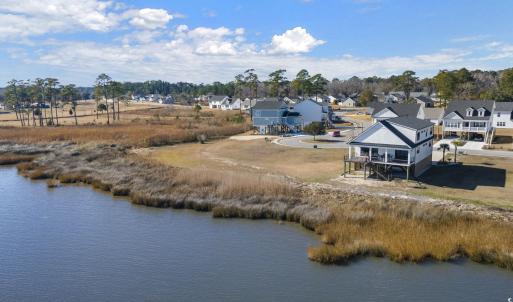 Birds eye view of property with a water view and a