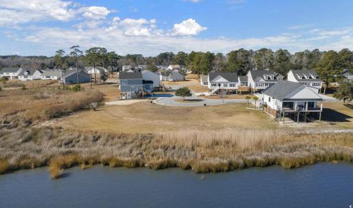 Birds eye view of property with a water view and a
