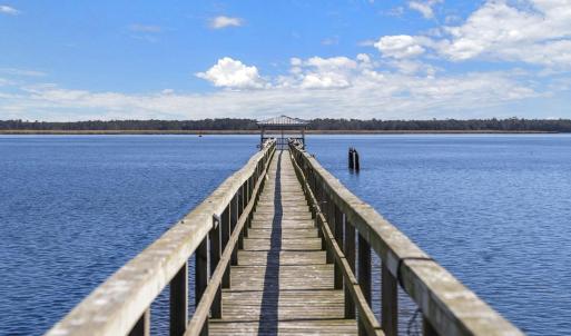 Dock area featuring a gazebo, a pier, and a water