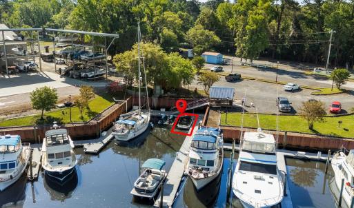 View of dock with a water view and a wooded view