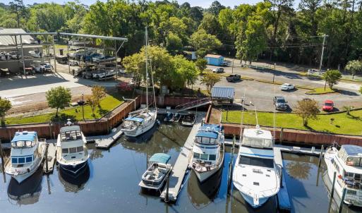 Dock area with a wooded view and a water view