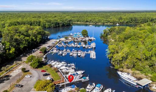 Drone / aerial view with a wooded view and a water