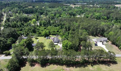 Birds eye view of property featuring a view of tre