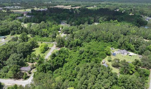 Birds eye view of property featuring a view of tre