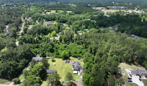 Aerial view featuring a wooded view
