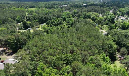 Aerial view featuring a wooded view