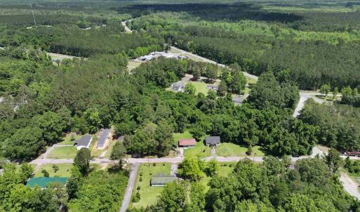 Birds eye view of property featuring a wooded view