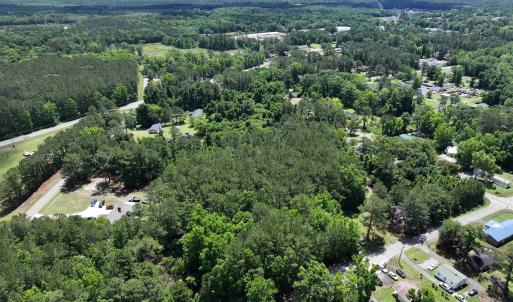Birds eye view of property with a wooded view