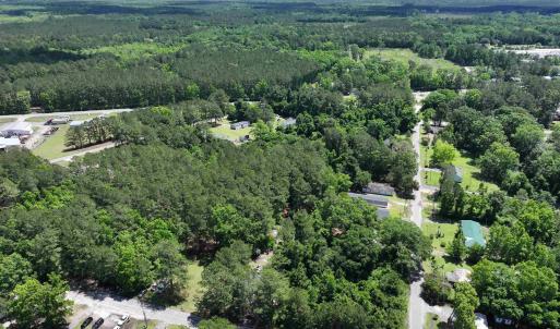 Birds eye view of property featuring a wooded view