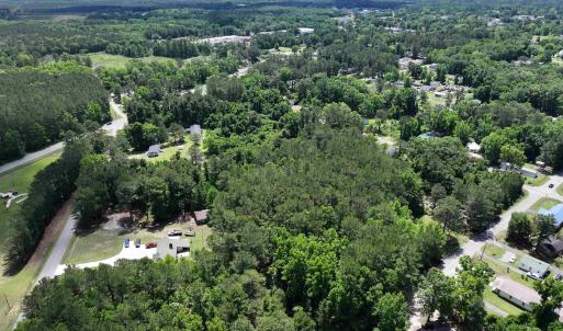 Aerial view featuring a forest view