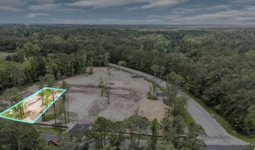 Birds eye view of property featuring a forest view