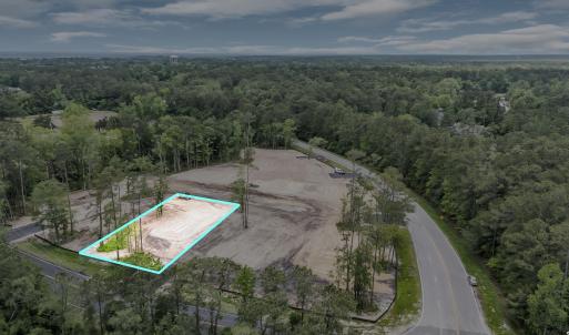 Birds eye view of property with a wooded view