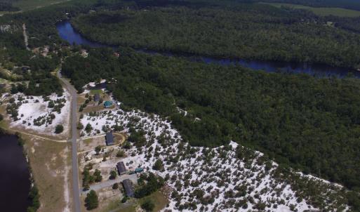 View of property location featuring a forest and a