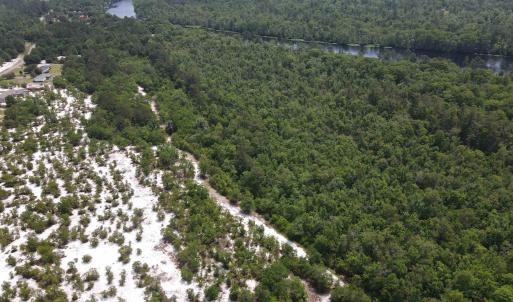 Drone / aerial view of a heavily wooded area and a