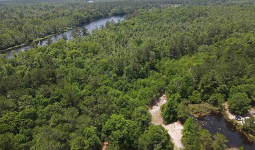 Drone / aerial view of a heavily wooded area and a