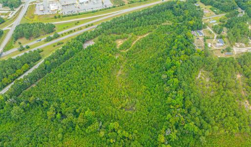 Aerial view of property's location with a forest