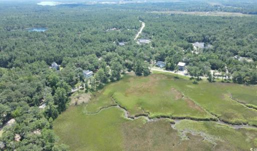 View of property location featuring a forest and a