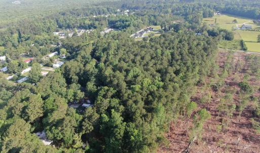 View of property location featuring a forest