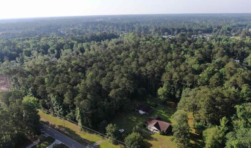 Aerial view of property's location with a forest
