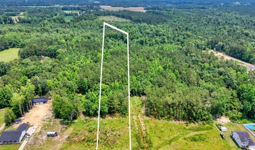 View of property location with a heavily wooded ar