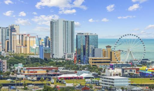 View of city skyline featuring a nearby body of wa