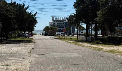 View of asphalt street featuring traffic signs