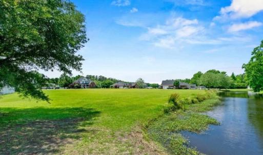 View of green lawn with a water view