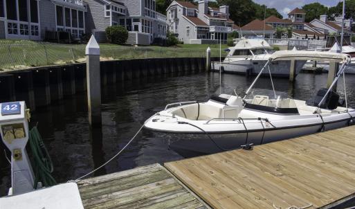 Dock area with a water view and a residential view