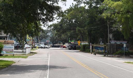 View of asphalt road featuring traffic signs