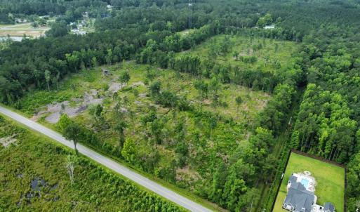 Aerial view of property's location with a forest