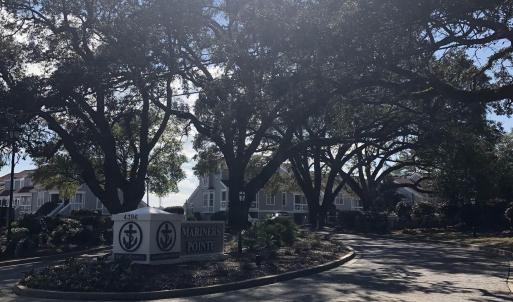View of asphalt road with curbs and a residential
