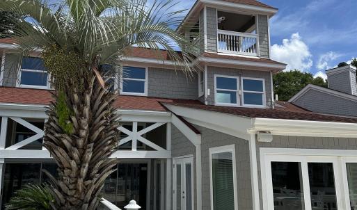 Back of property featuring a balcony, french doors