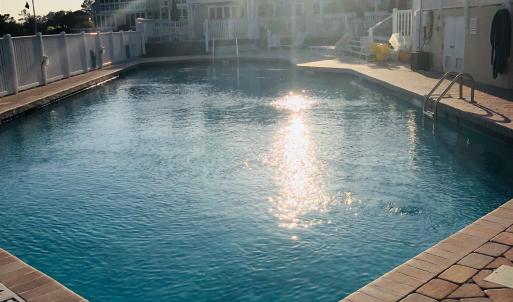 Community pool with a patio area