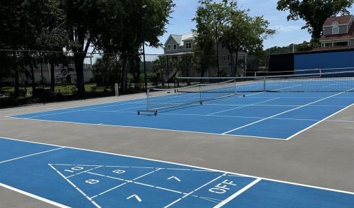 View of community with a tennis court