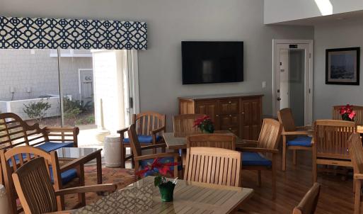 Dining space with a towering ceiling, wood finishe