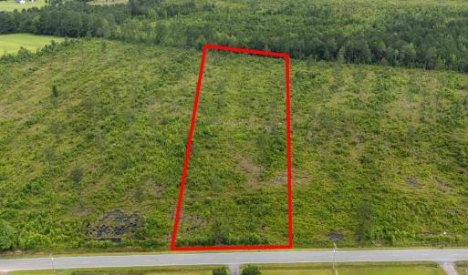 View of property location with a forest and proper