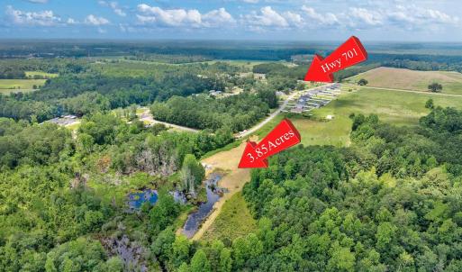 Aerial view of property's location with a forest